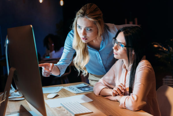 Two women working together on a computer